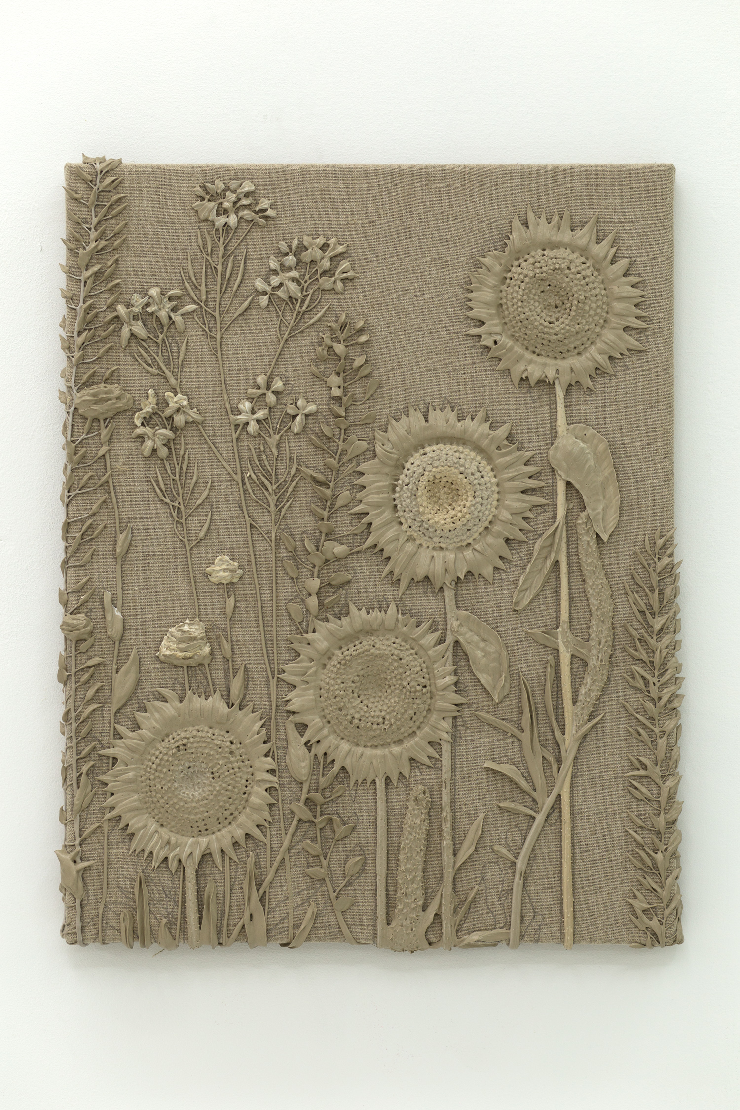 Brown monotone plastic painting of four sunflowers and assorted other plants