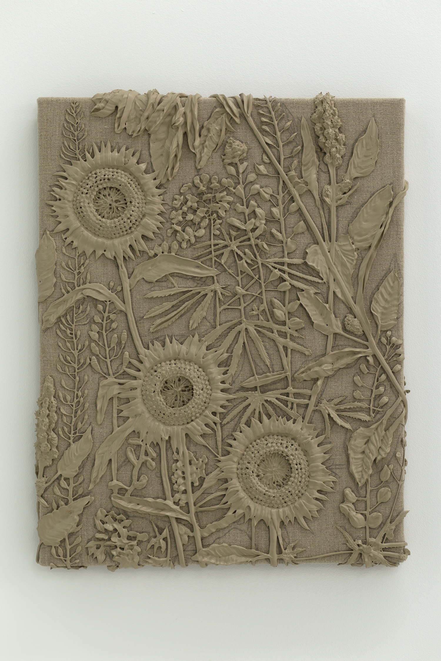 Brown monotone plastic painting of three sunflowers and assorted other plants